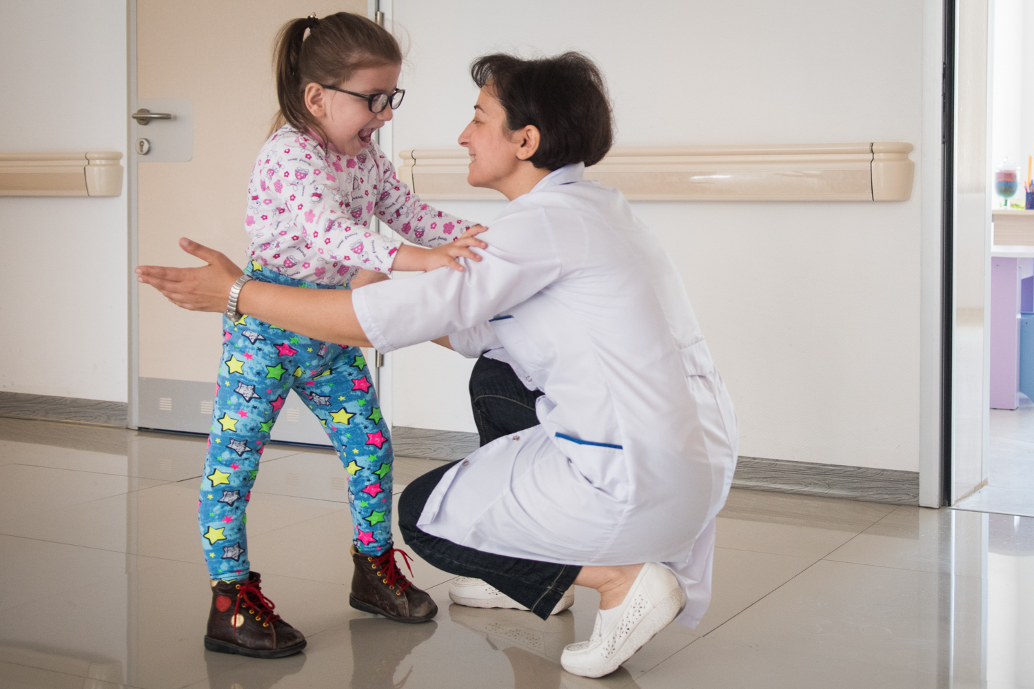 Baku Rehabilitation Centre. As a sign of recognition the caregiver embrace her patience, proud of the work done. The close bondage that the caregiver built with her patience has a very strong motivation for the patience to keep on working.