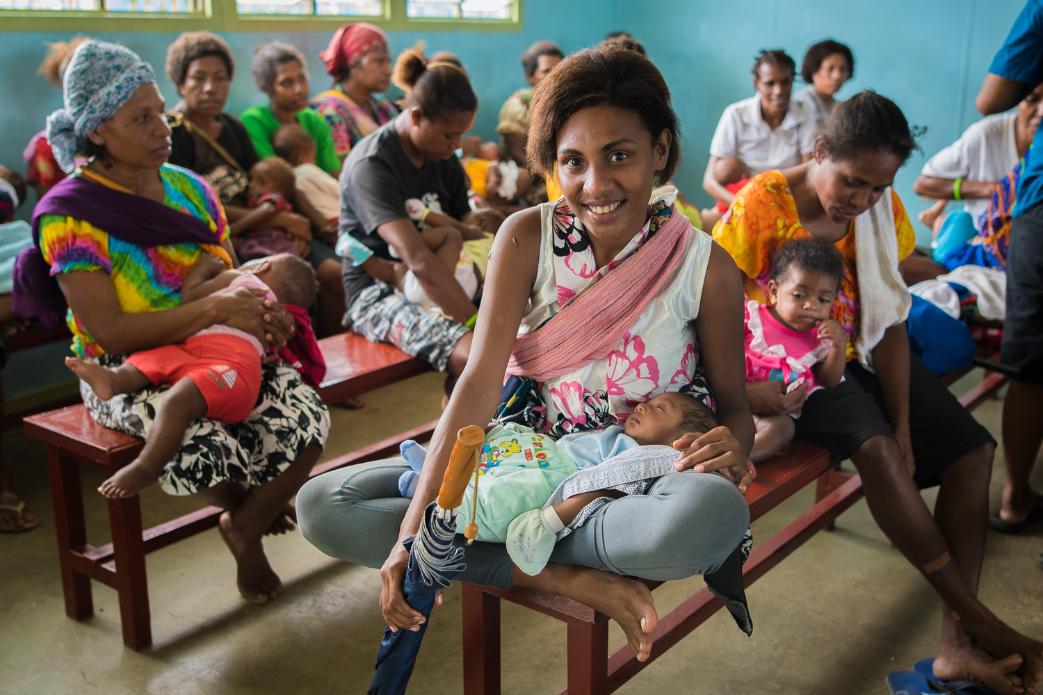 Jomba Urban Clinic in Madang. A group of women are waiting to be attended at the Jomba to immunize their children. The life-time risk of maternal death is eight times higher in PNG than in East Asia and Pacific region average.