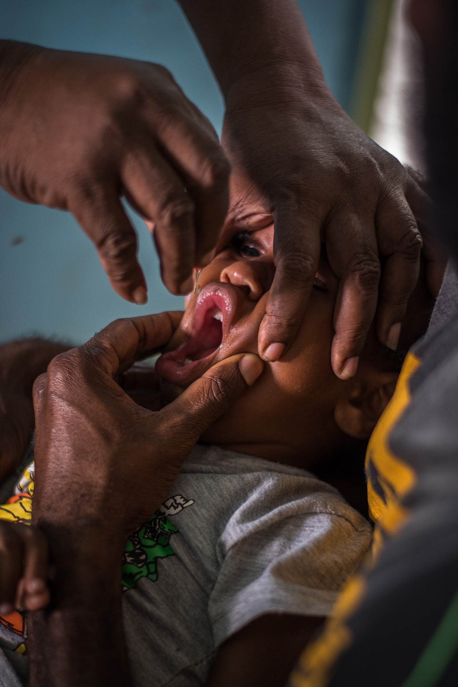A boy is being vaccinated by mouth at the Jomba Urban Clinic in Madang for immunization. UNICEF procures all vaccines for routine and supplementary immunization activities in the country.