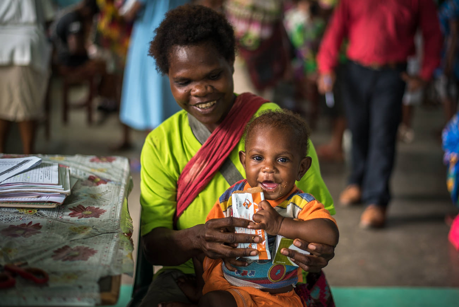 A mother is feeding her son with nutritional supplements at the Jomba Urban Clinic. Nearly 50% of Papua New Guinea’s Children are Malnourished.