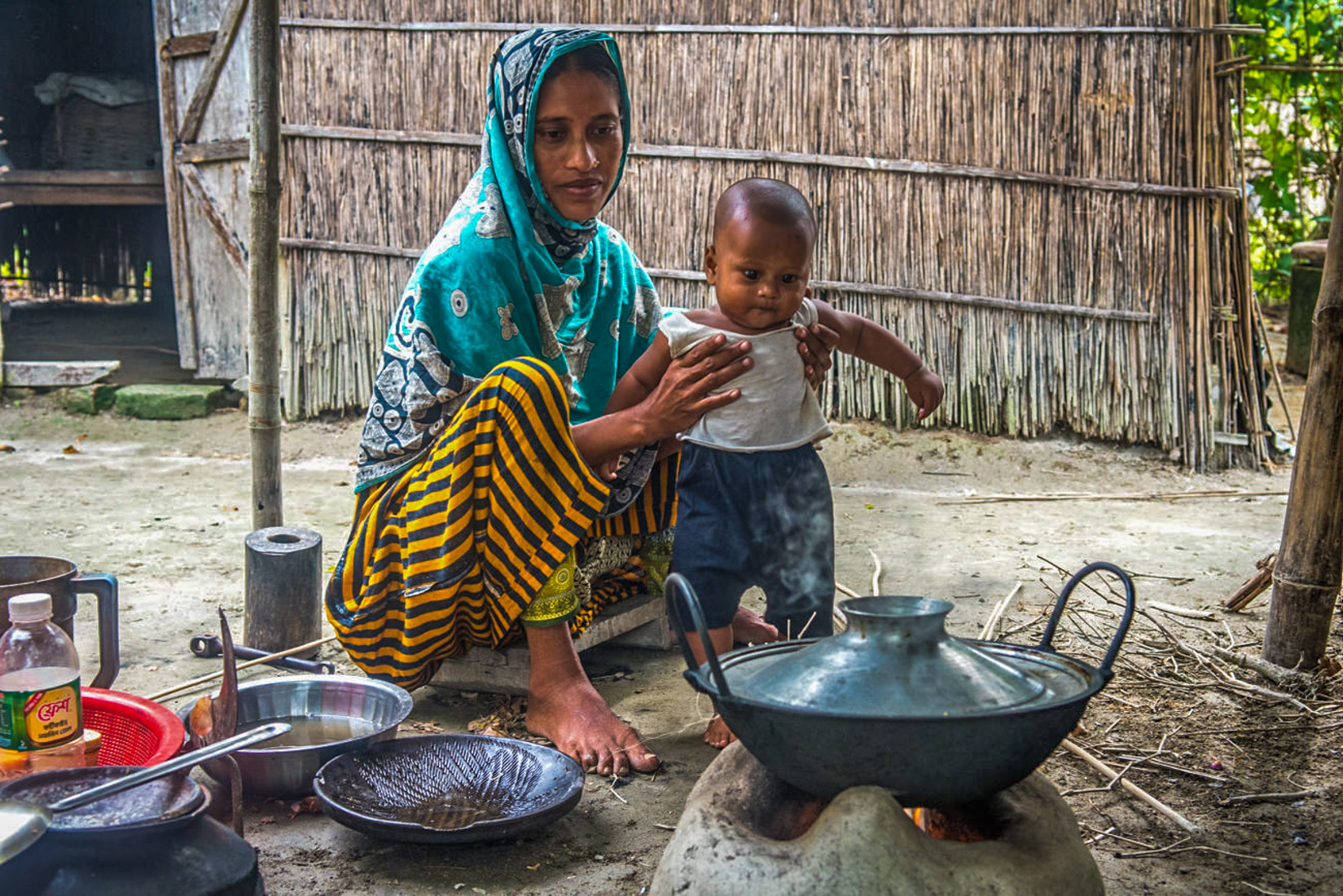 Mosammat Morsheda with her baby living in Charitabari cluster village. The devastating floods of August 2017 didn’t affect her nor the villagers of her community as the land level was raised 9 feet from the water level to be more secure from floods.