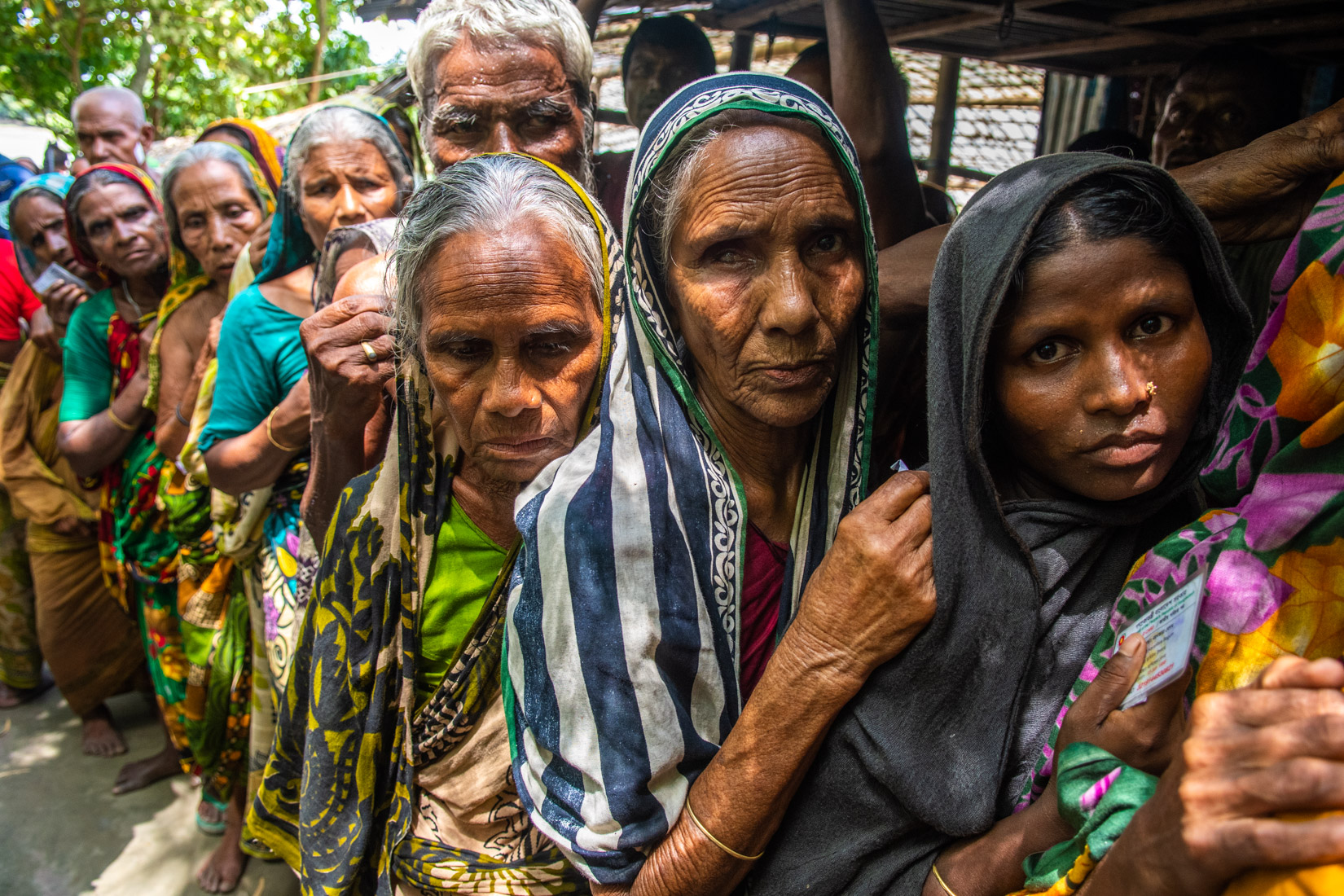 Gaibandha district. Aged women are waiting in the que to be listed for emergency response recipient at Badshah Miah’s home yard on 29 August 2017.
