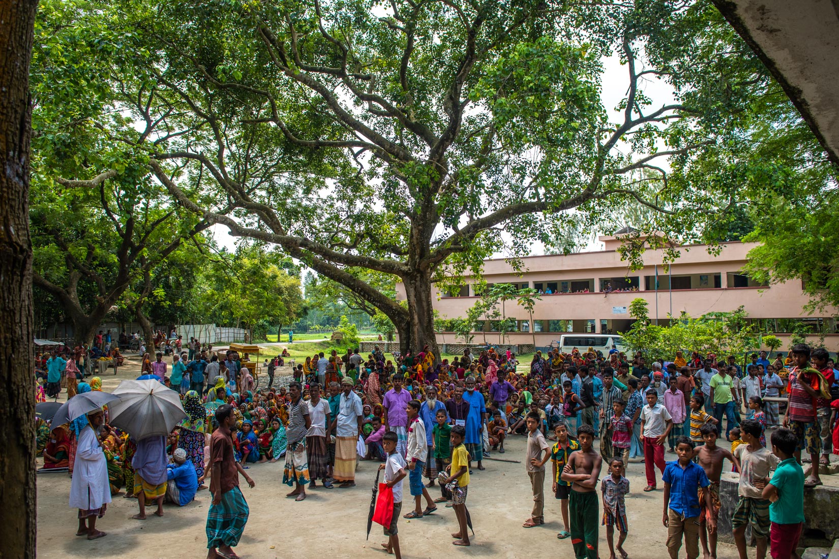 Relief materials is being downloaded from a truck at Pachpir Primary school ground.
