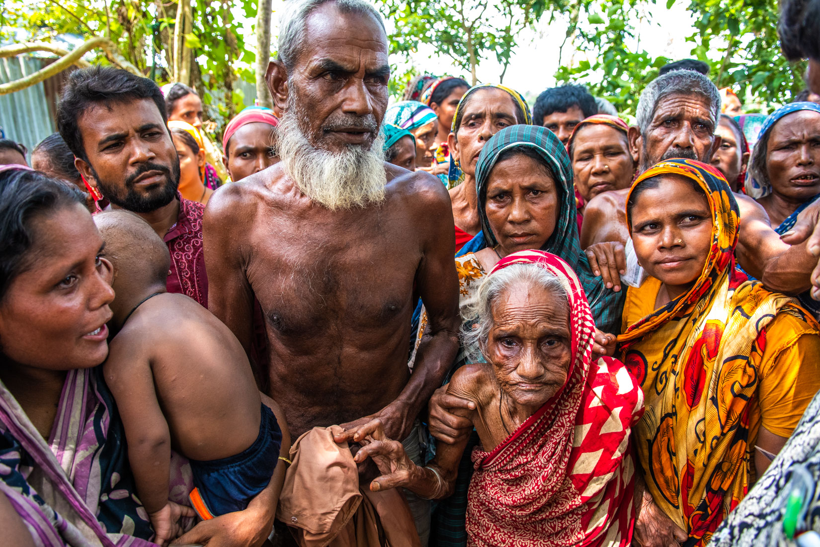People in disparate situation and urgent need of assistant gather at the distribution point, waiting for new information about the time the distribution of merchandise will take place.