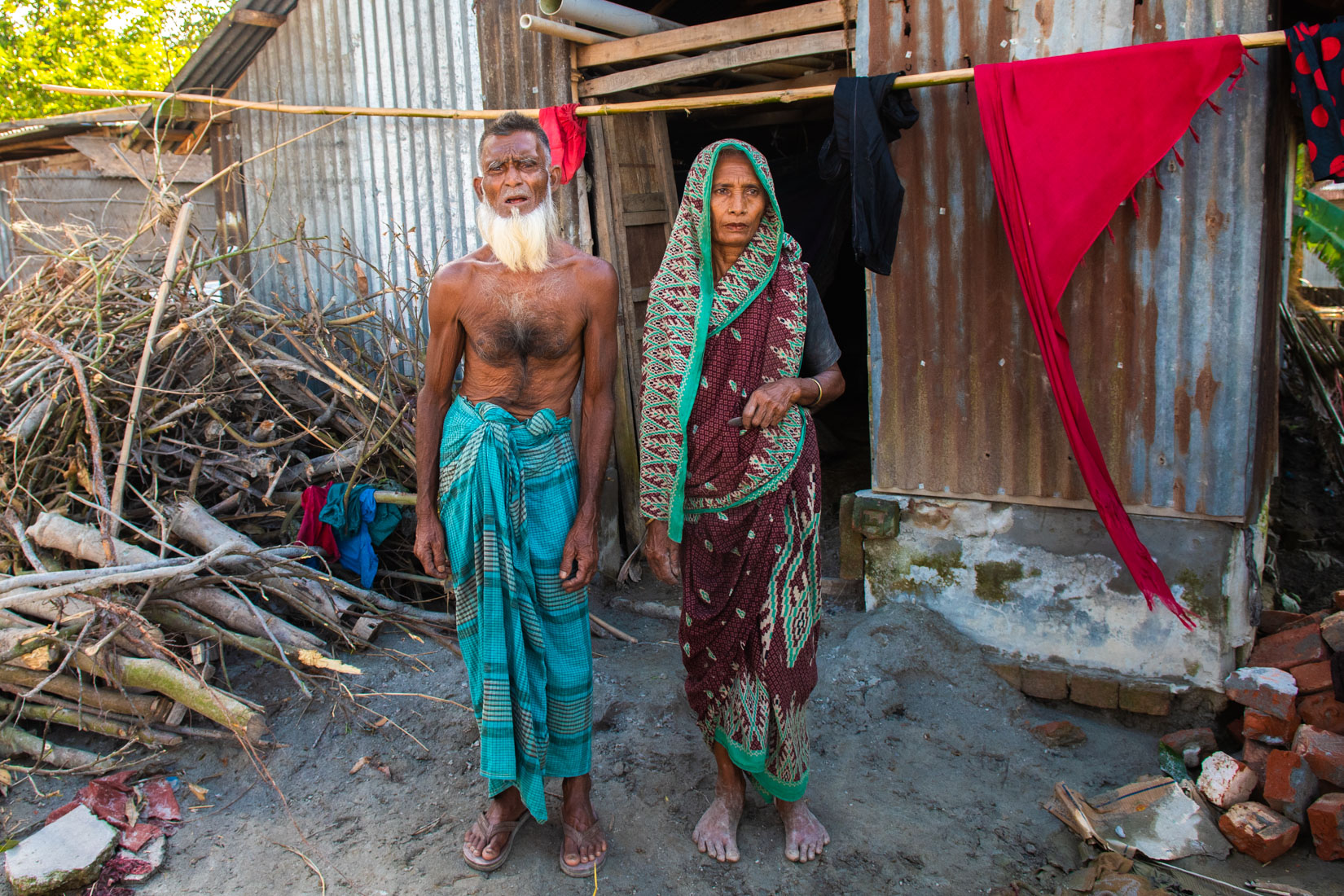 Shamsul Haque and his wife Mosammat Rahima Begum (55) put at safe their stuff in a temporary shelter on the river embankment. Their house was destroyed in the flood. They manage to brought some of their household goods with them.
